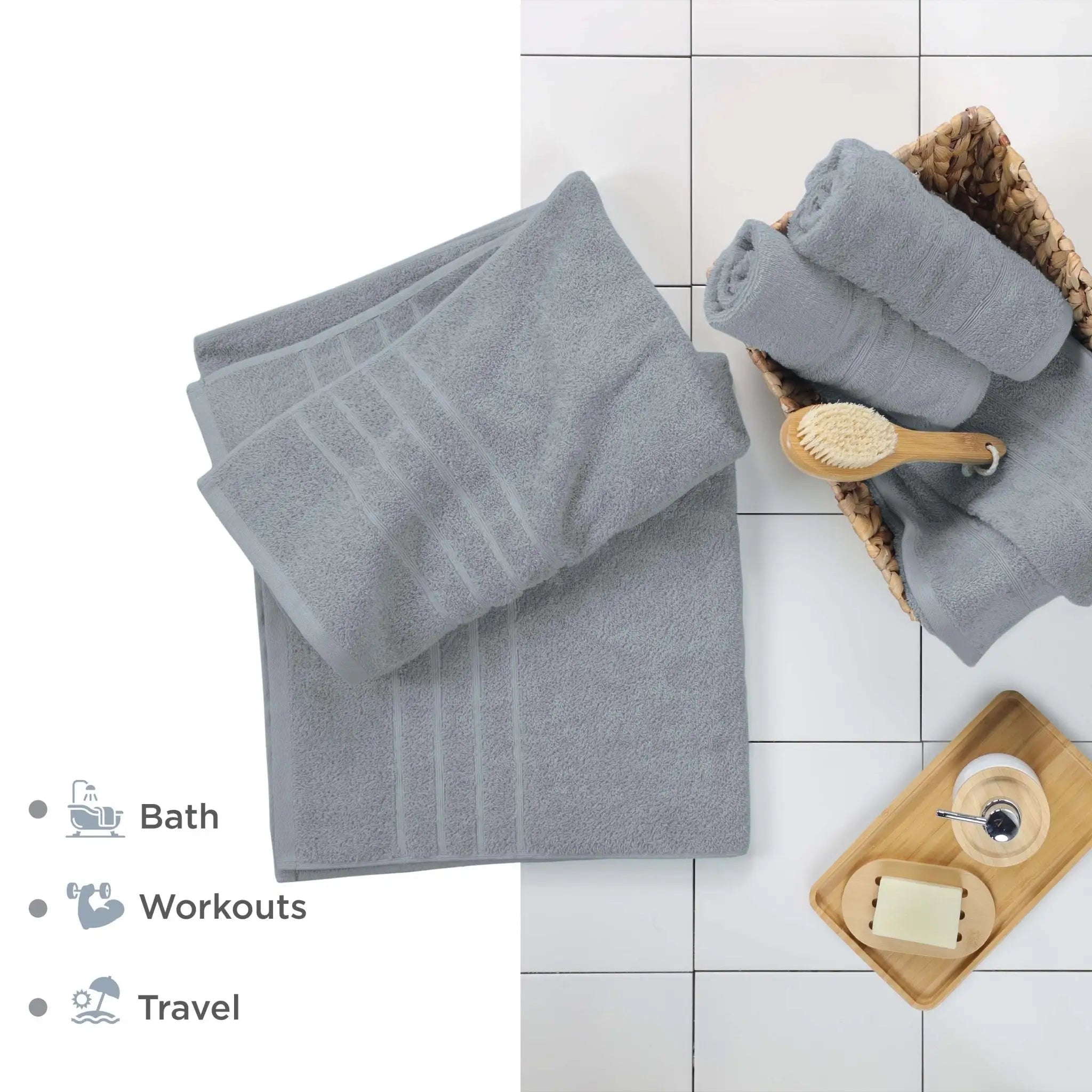 Spa blue bath sheets shown folded on a white tiled surface. Text on the left lists uses: Bath, Workouts, and Travel.
