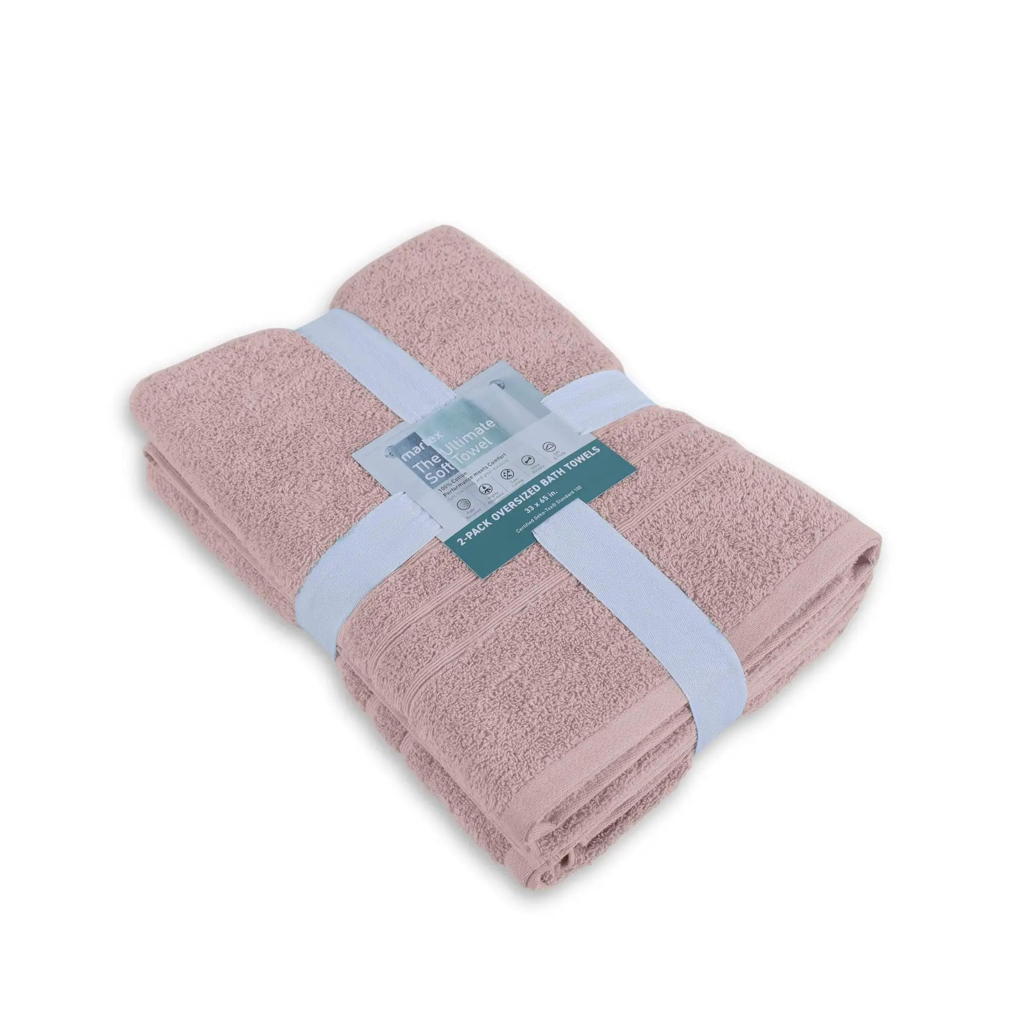 Folded pink bath sheets with a label on a white background