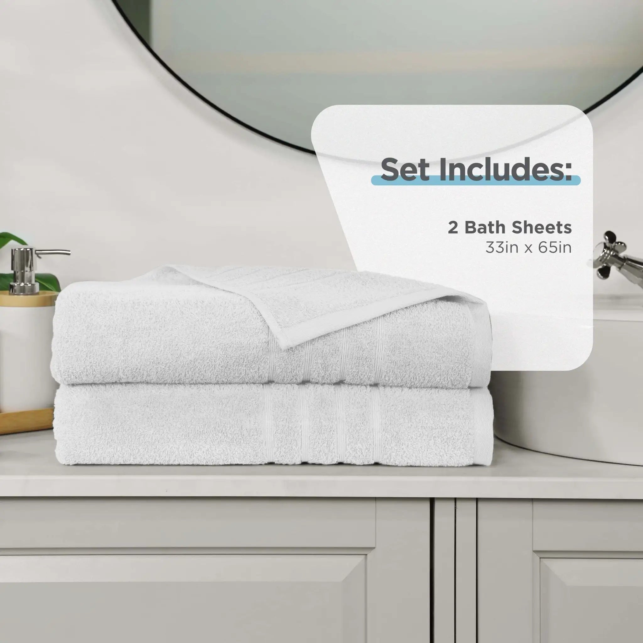 Two folded white bath sheets stacked on a bathroom counter, with a white informational overlay that reads 'Set Includes: 2 Bath Sheets 33in x 65in.' A sink, mirror, soap dispenser, and cabinet are visible in the background.
