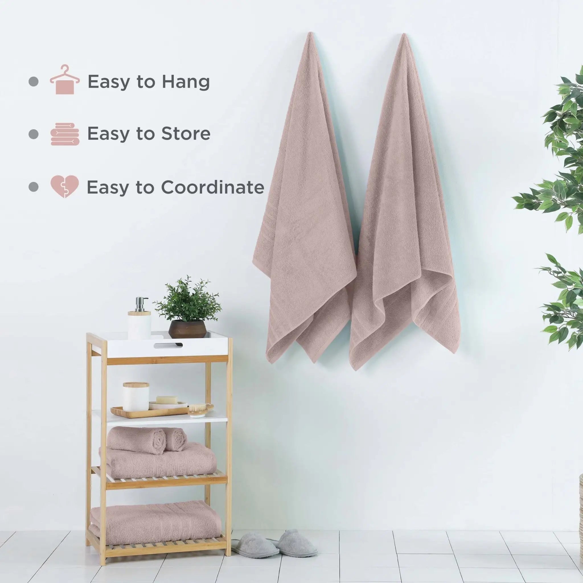 Two pink bath sheets hanging on a white wall in a bright bathroom setting, with text callouts on the left listing features like easy to hang, easy to store, and easy to coordinate.