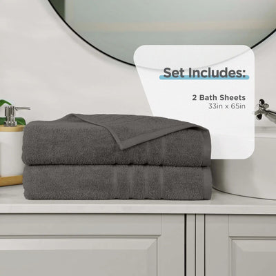 Two dark grey bath sheets on a bathroom counter with product details overlay.