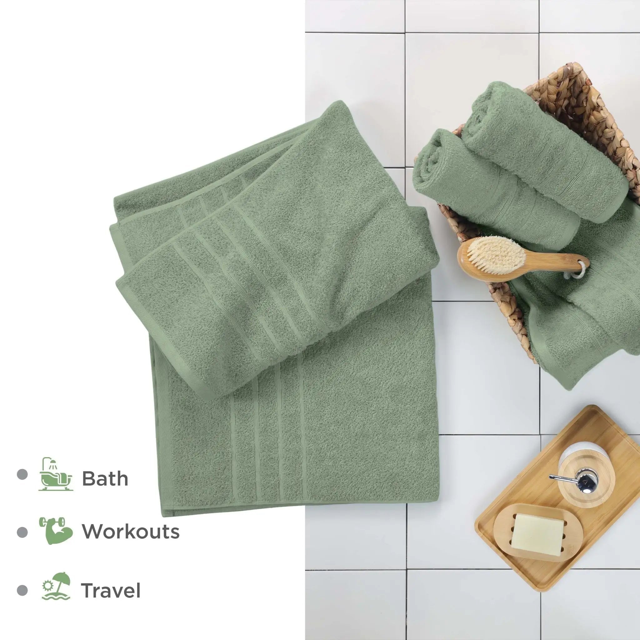 Sage bath sheets on a white tiled floor with bathroom accessories.
