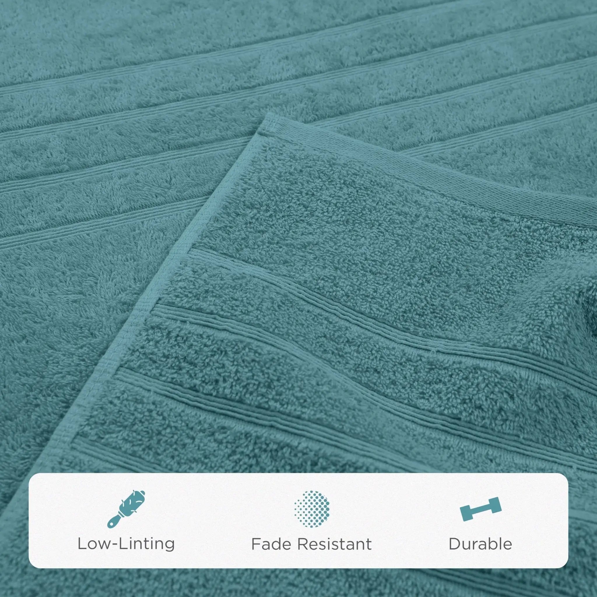 A close-up of a teal bath sheet with horizontal ribbed stripes, showing its soft terry texture. A white banner at the bottom features icons and text highlighting product features: 'Low-Linting', 'Fade Resistant', and 'Durable'.