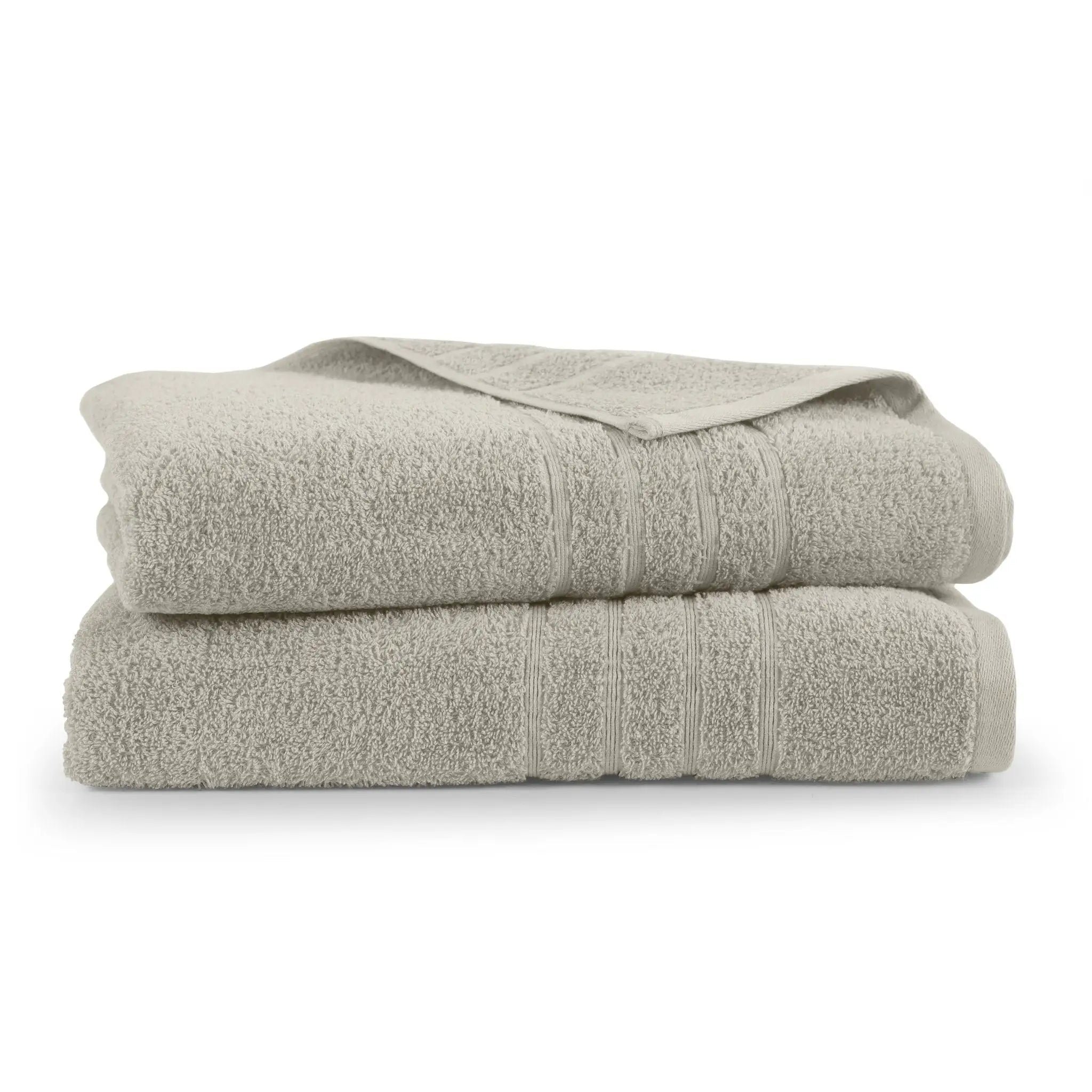 Two folded sand colored bath sheets on a white background