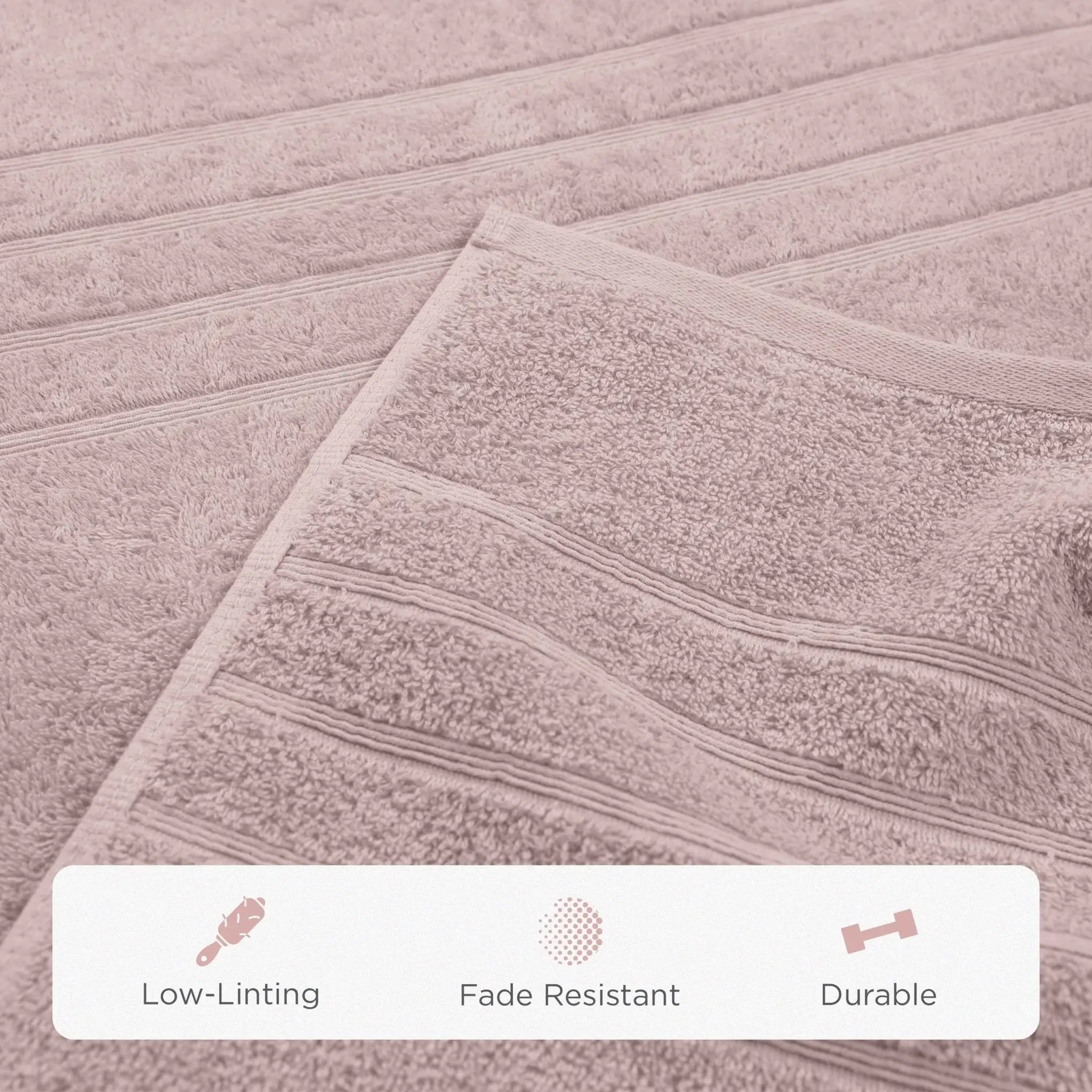 A close-up of a pink bath sheet with horizontal ribbed stripes. A white banner at the bottom features icons and the text 'Low-Linting', 'Fade Resistant', and 'Durable'.