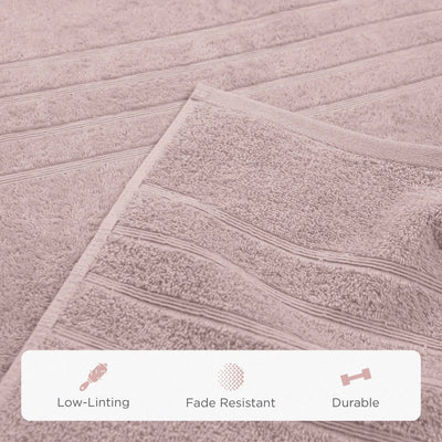 A close-up of a pink bath sheet with horizontal ribbed stripes. A white banner at the bottom features icons and the text 'Low-Linting', 'Fade Resistant', and 'Durable'.