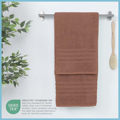 Terracotta bath sheet hanging on a rack, featuring OEKO-TEX certification.