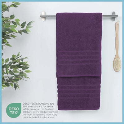 Dark purple bath sheet hanging on a rack, featuring OEKO-TEX certification.