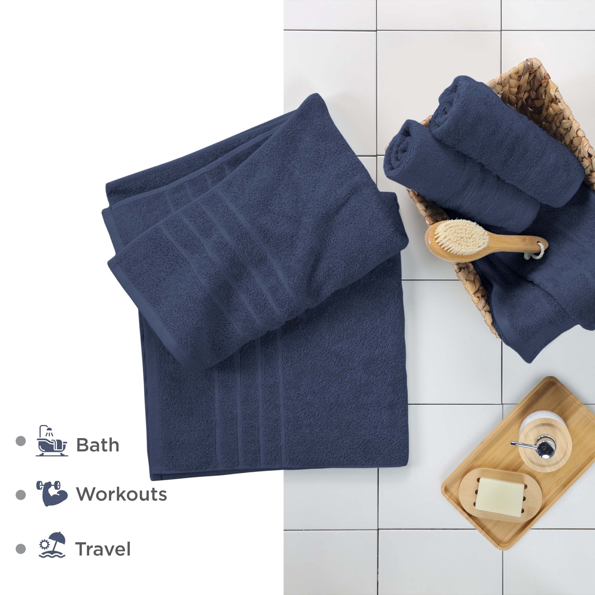 Estate blue bath sheets on a tiled floor with bath accessories.