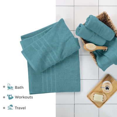 Larkspur Teal bath sheets on a tiled floor with bath accessories.