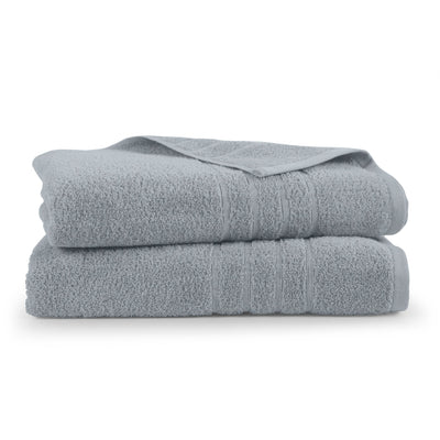 Two folded spa blue bath sheets on a white background