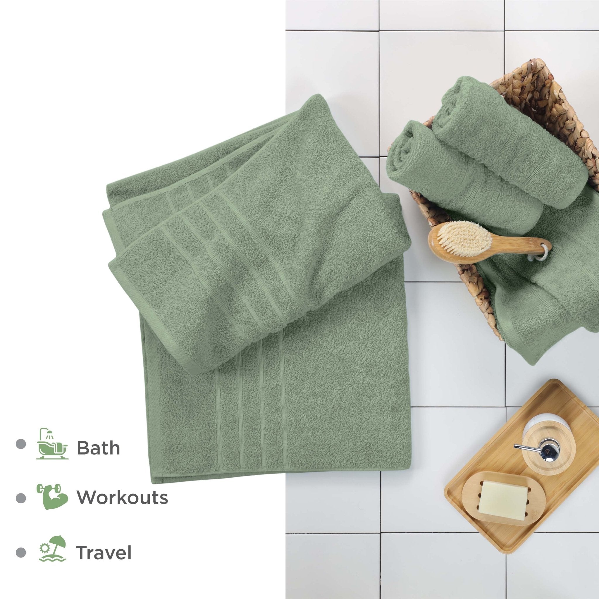 Sage bath sheets on a tiled floor with bath accessories.
