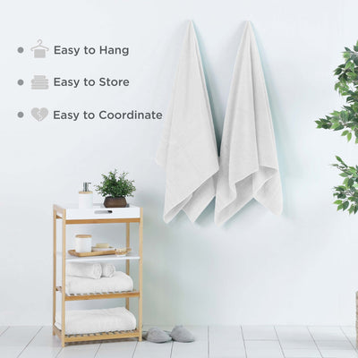 Optical white bath sheets hanging on a wall, featuring text about towel features.