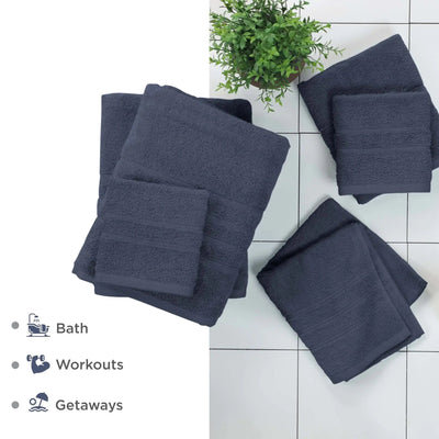 Set of blue towels on a white tiled floor with a plant in the background.