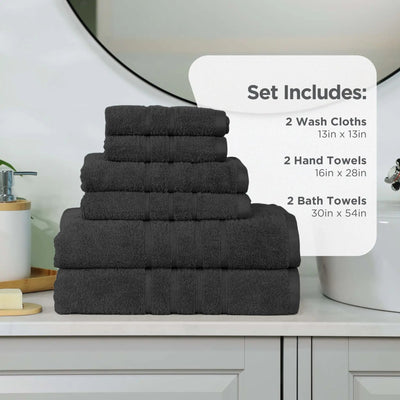 A stack of black towel set on a bathroom counter, with a white text box overlay detailing the set contents: 2 wash cloths, 2 hand towels, and 2 bath towels.