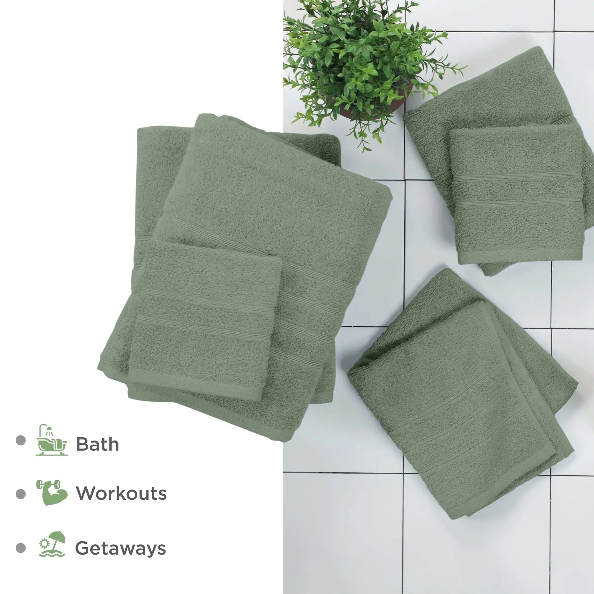 Set of sage towels on a tiled floor with a plant in the background.