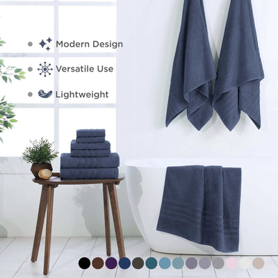 A set of blue towels displayed in a bright bathroom setting, with a stack on a wooden stool. Text on the left highlights modern design, versatile use, and lightweight features, with a color swatch row at the bottom.