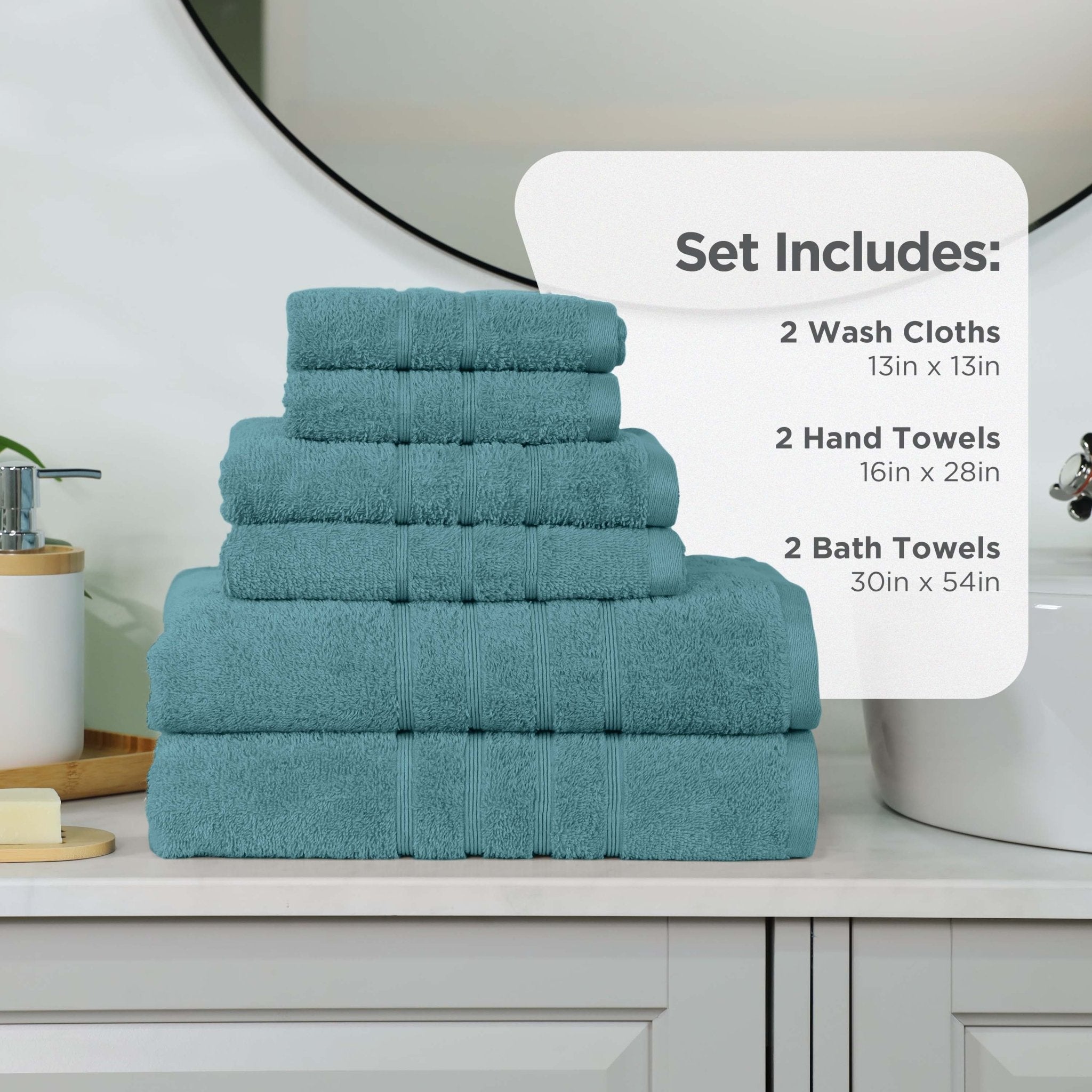 Set of larkspur teal towels including wash cloths, hand towels, and bath towels on a bathroom counter.