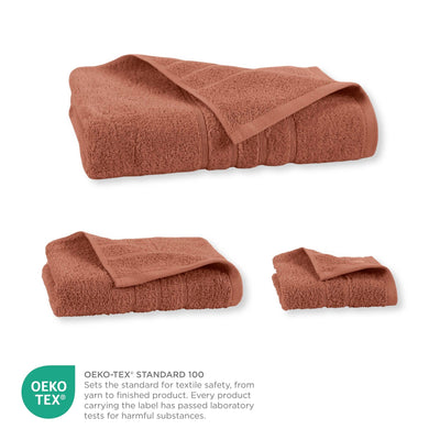 Terracotta folded towel with OEKO-TEX certification label on a white background