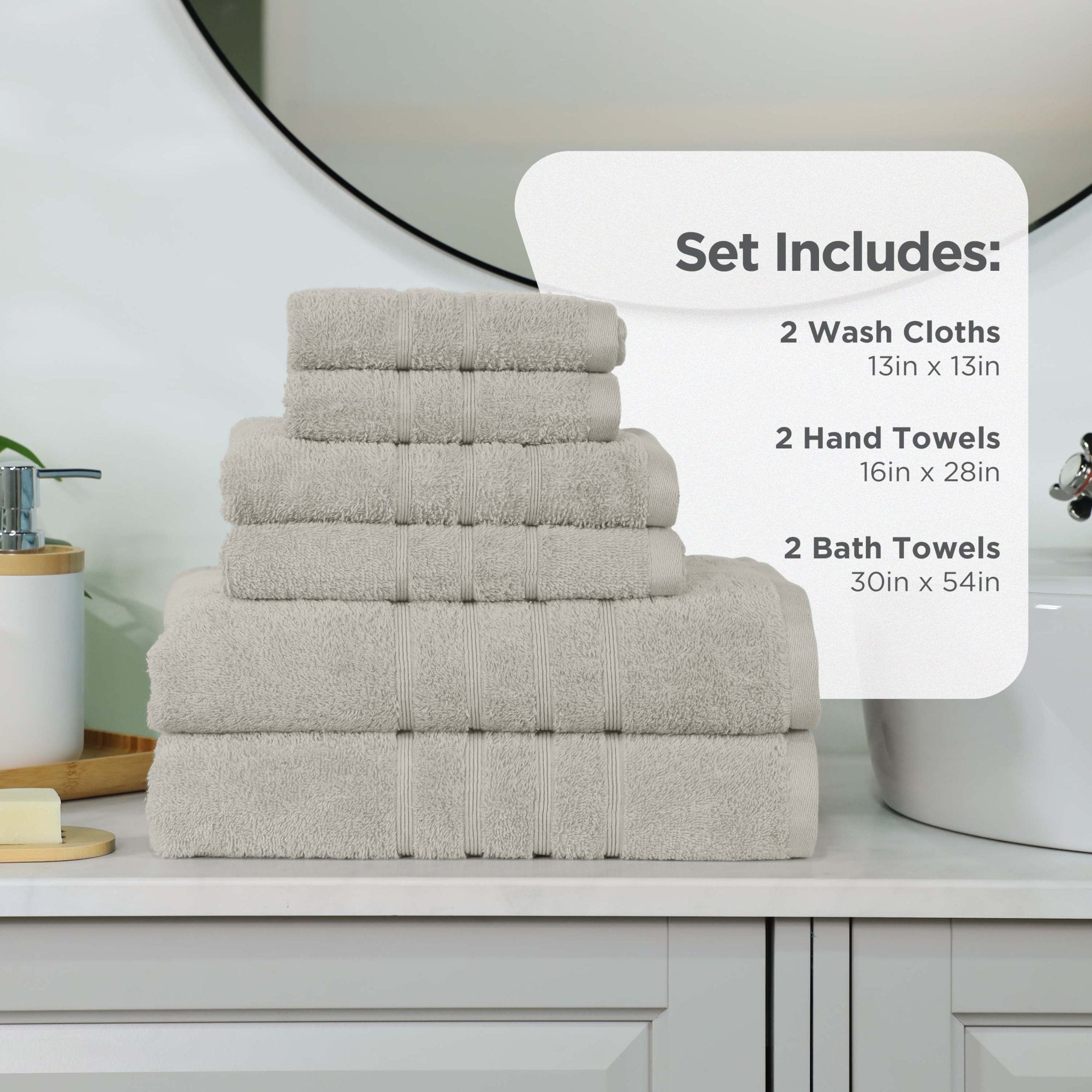 Set of towels including wash cloths, hand towels, and bath towels on a bathroom counter.