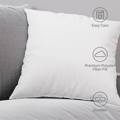 White pillow on a gray couch with care instructions displayed.