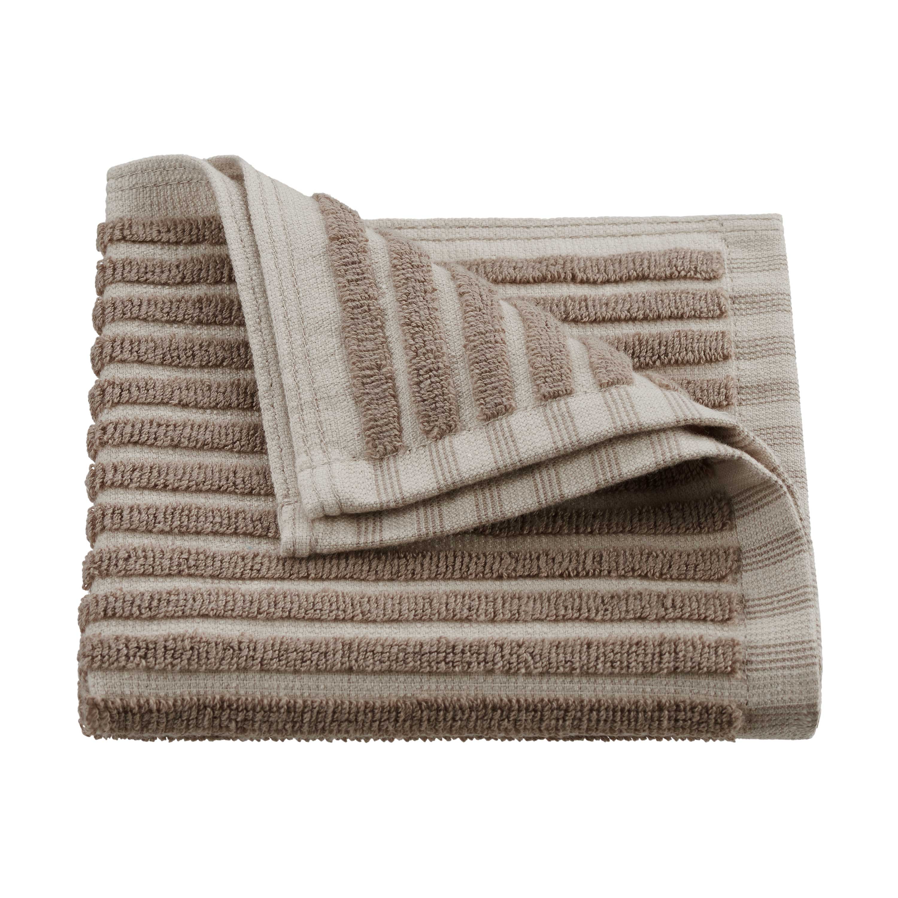 Folded towel with sculpted stripes in beige and light brown colors.
