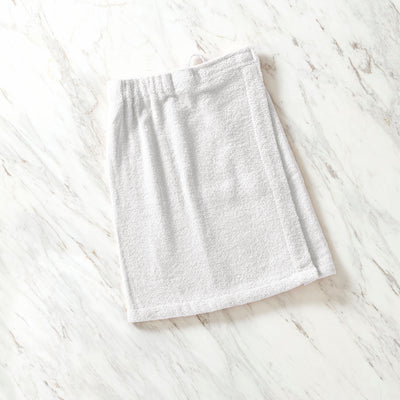 Light gray youth shower wrap with an elastic waistband, laid flat on a marble surface.