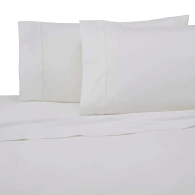 White bed sheet and pillowcase set on a bed against a white background.