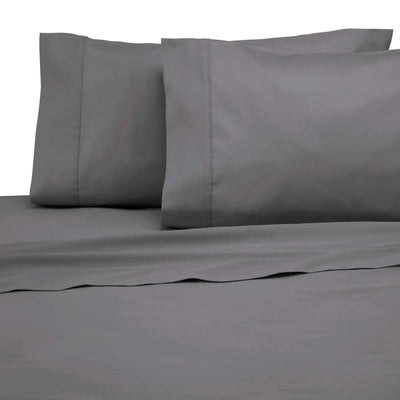 Gray bed sheets and pillowcases on a plain background
