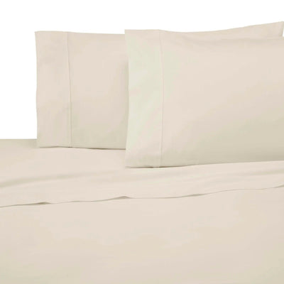 Ivory cotton sheet and pillowcase set on a bed, featuring a smooth texture and classic pillowcase design.