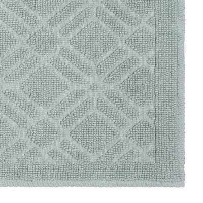 Light gray bath rug featuring a textured geometric pattern with a bordered edge.