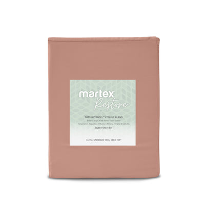 Solid peach-colored sheet set with a label detailing material and features, designed for queen-sized beds.