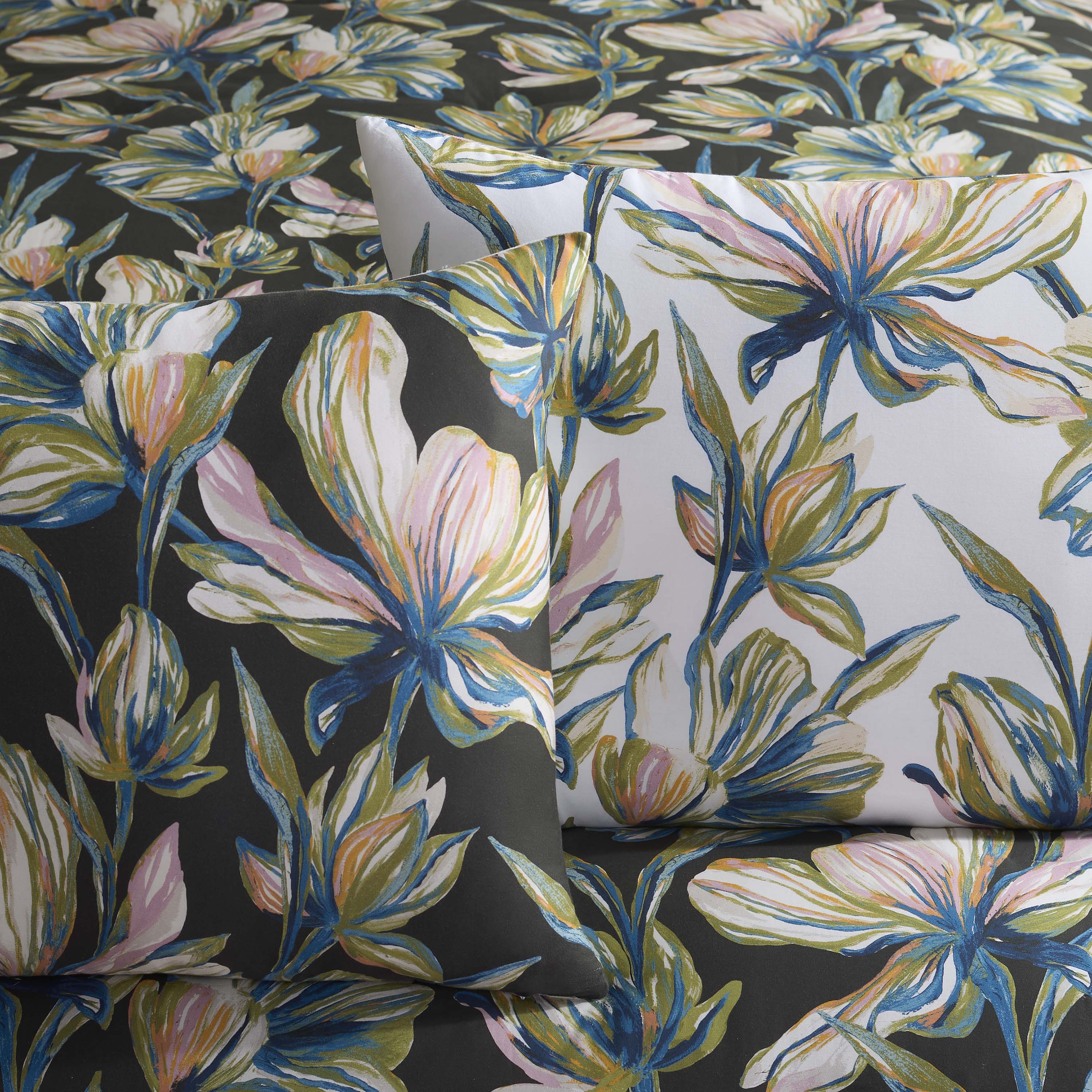 Comforter set featuring a floral design with large, colorful flowers on a dark background and coordinating pillowcases.