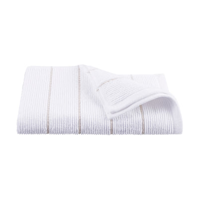 White towel with textured stripes and a folded corner, showcasing a soft, absorbent fabric.