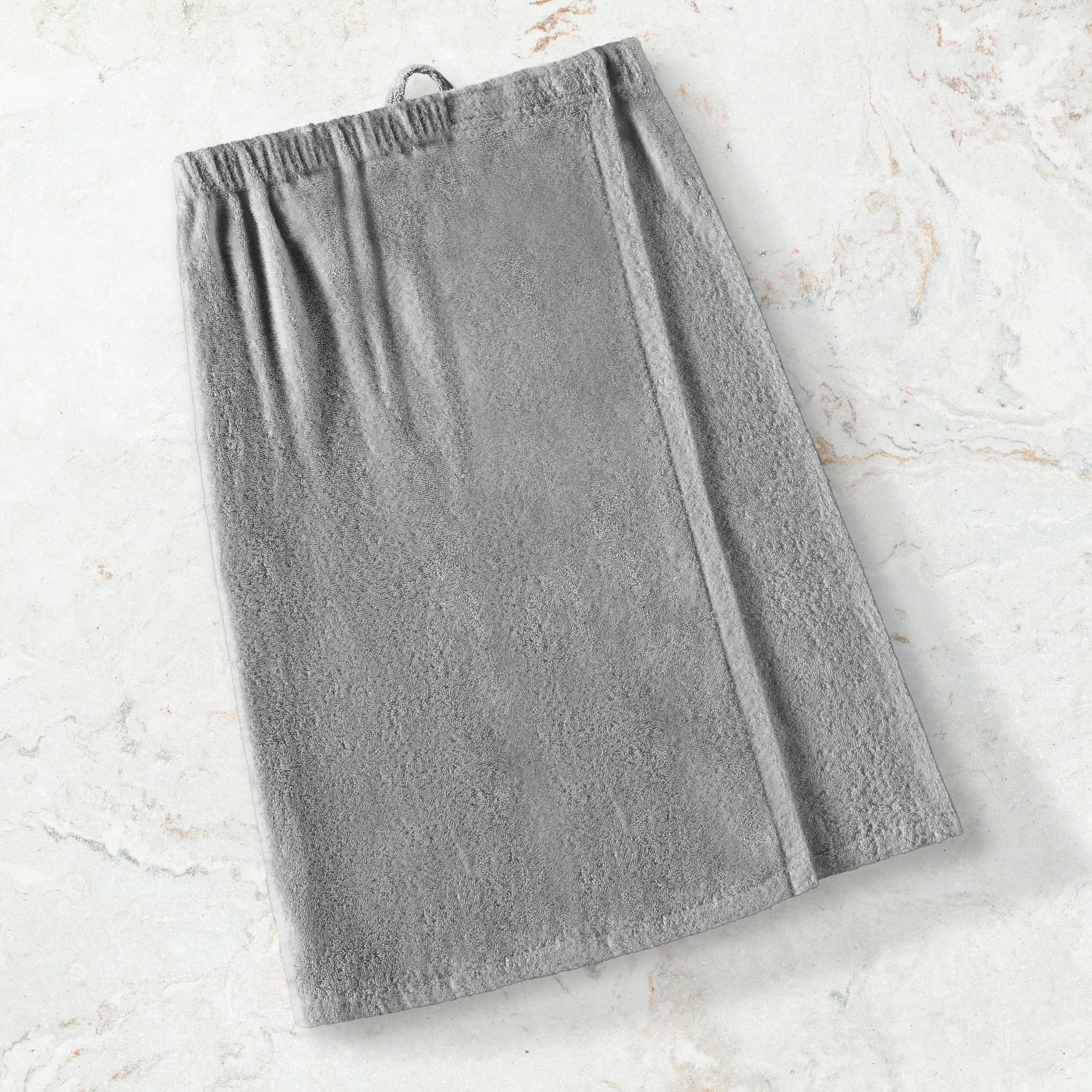 Gray adult shower wrap with an elastic waistband and a loop for hanging, placed on a light marble surface.