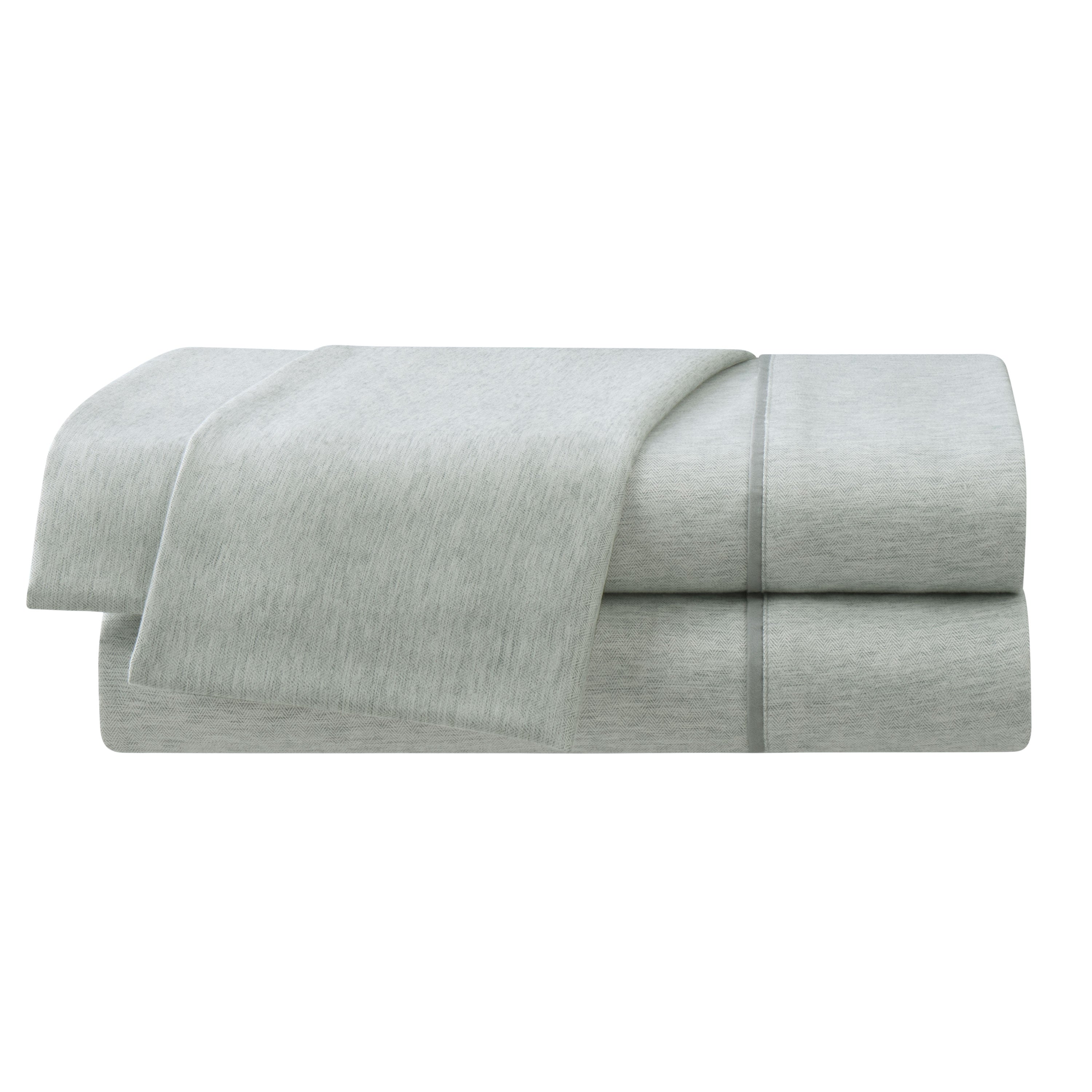 Light gray herringbone sheet set with a smooth texture, featuring folded sheets stacked neatly.