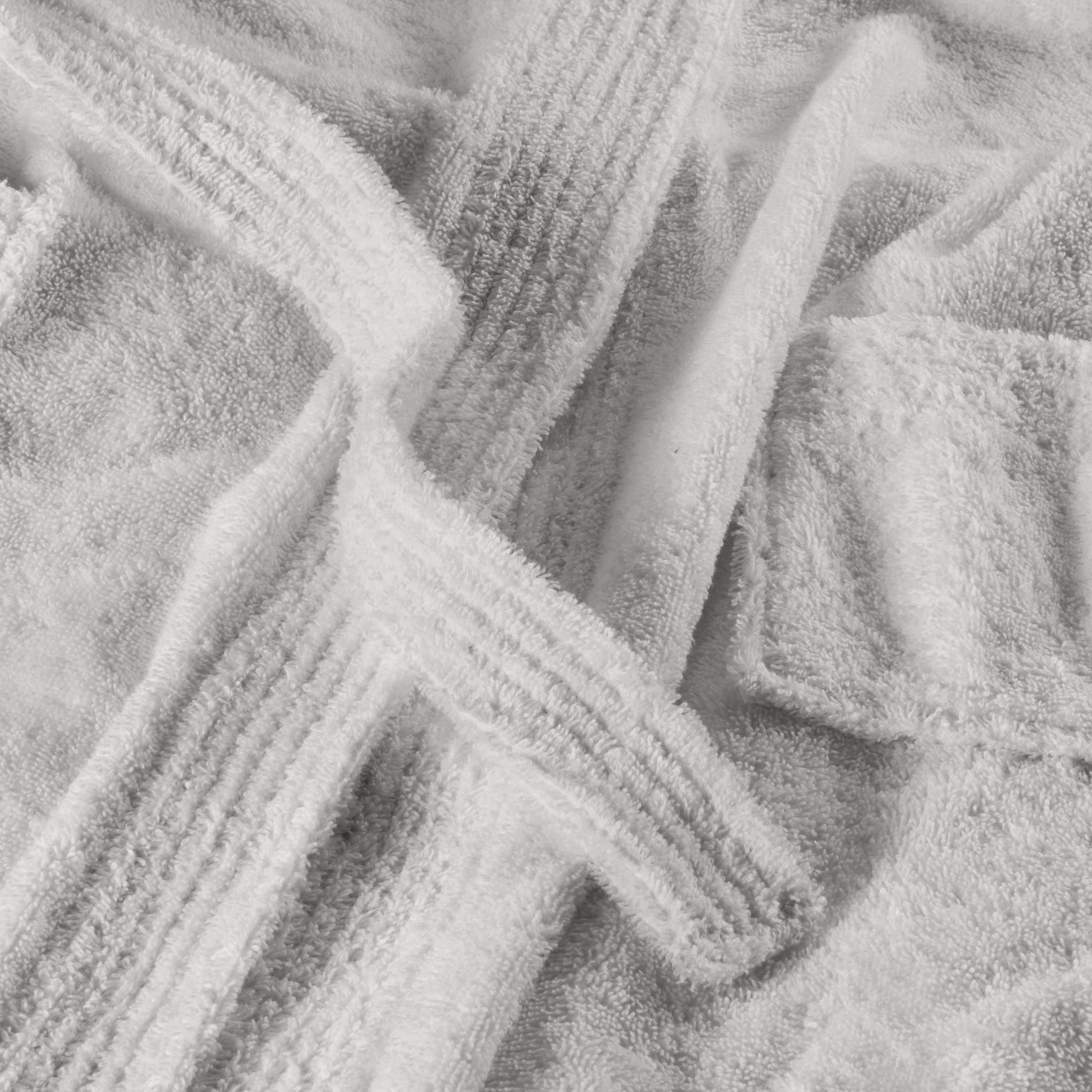 White hooded bath robe with textured fabric and tied belt, laid out flat.