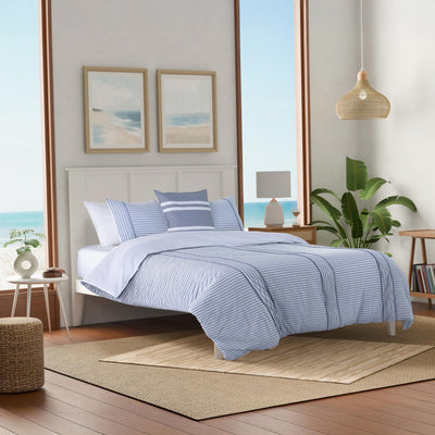 Bedroom with blue striped comforter set.