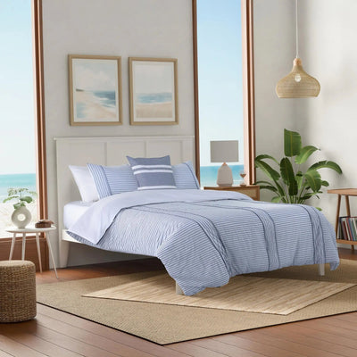 Bedroom with blue striped comforter set.
