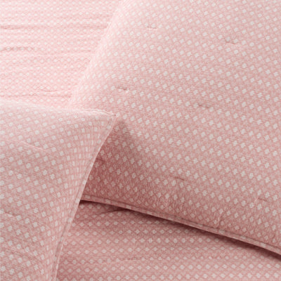 Close-up of pink euro sham with a subtle pattern