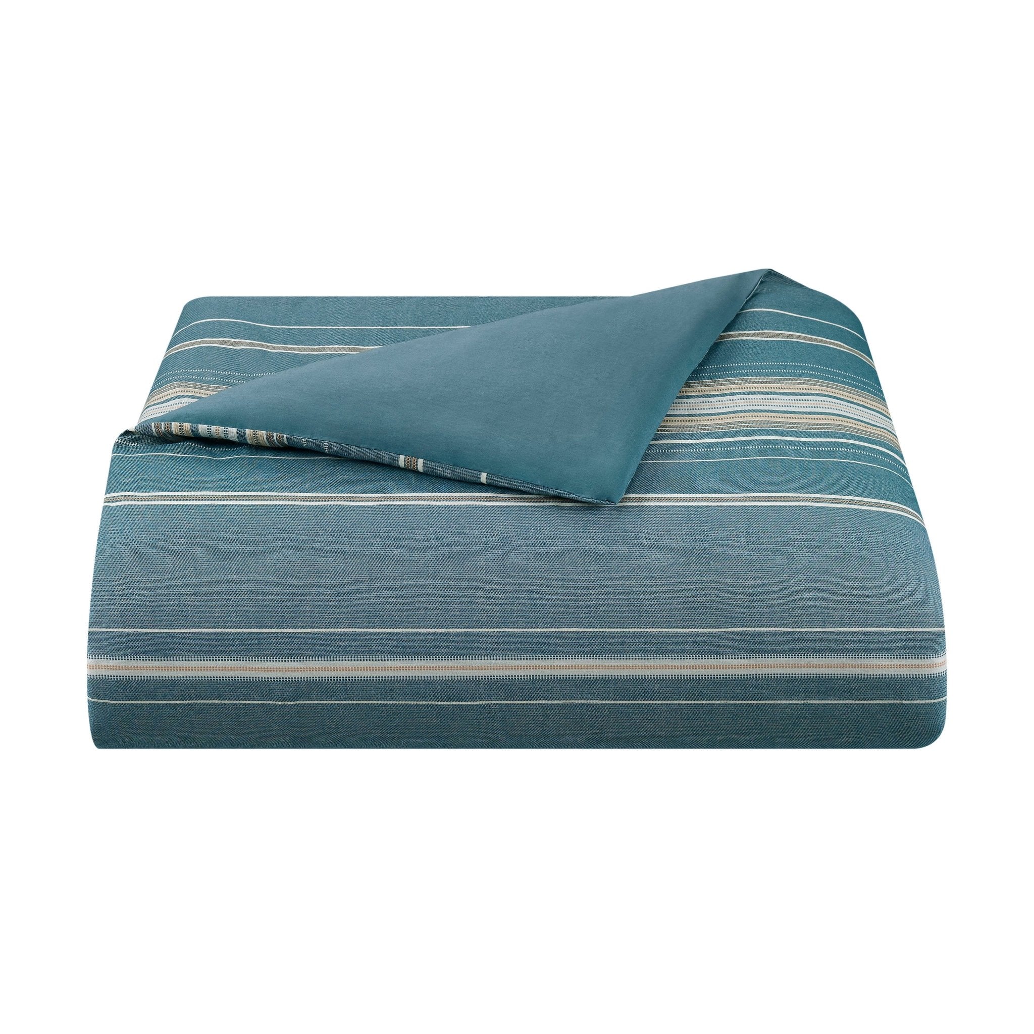 Blue striped comforter on a white background