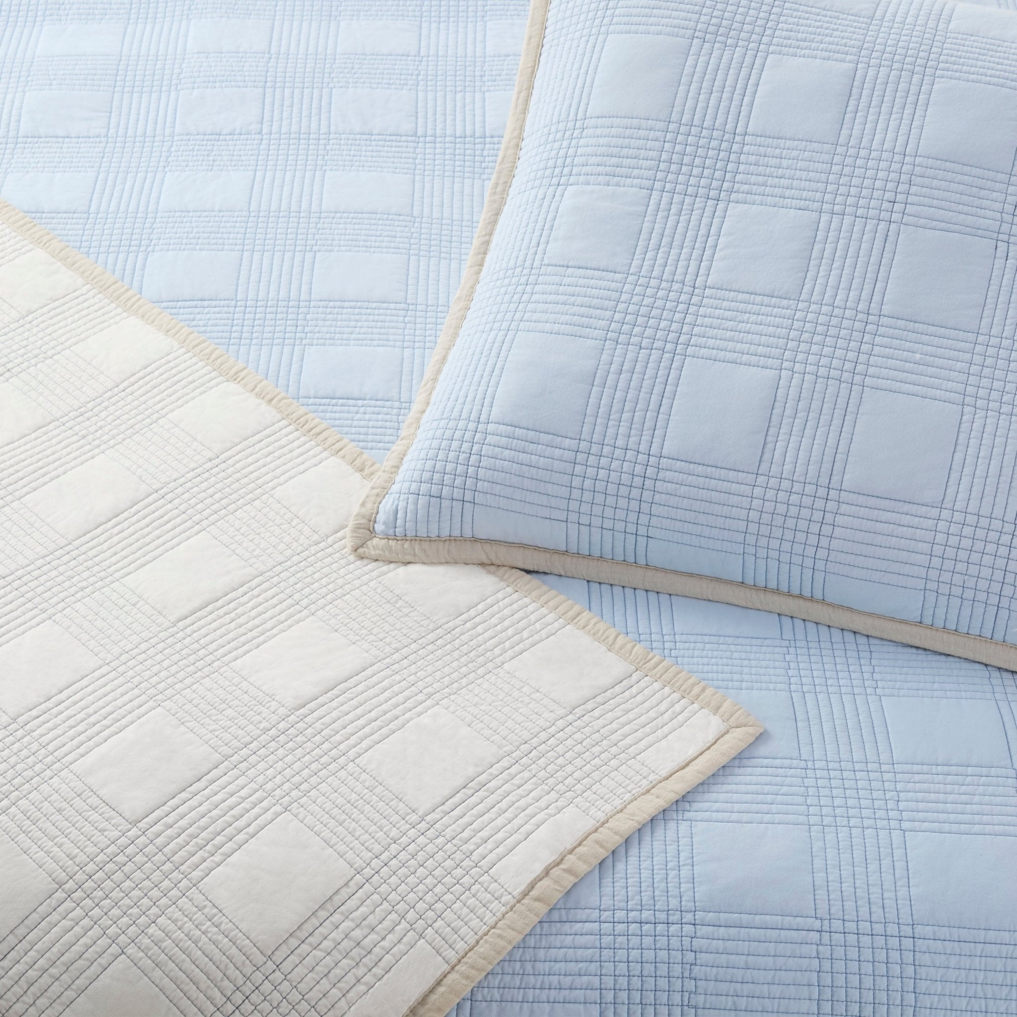 Close-up of light blue and beige quilted fabric