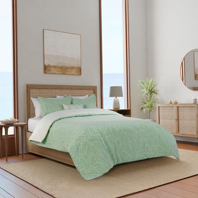 Bedroom with green leaf-patterned comforter set