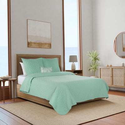 Bedroom with mint green bedding.