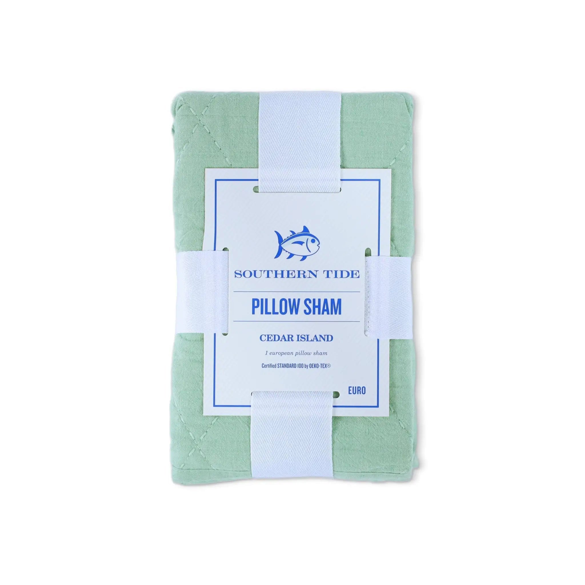 A folded sage green pillow sham wrapped in a white paper band with a white paper label that reads 'SOUTHERN TIDE PILLOW SHAM CEDAR ISLAND'.