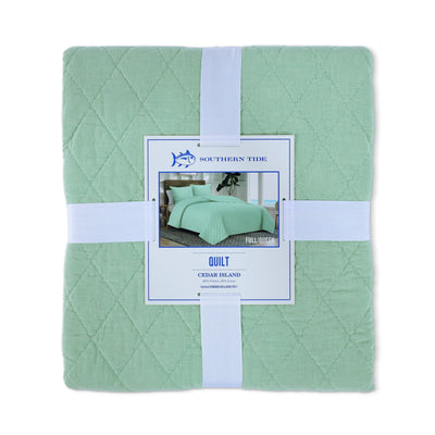 Front view of green quilt packaging with a tag displaying 'Southern Tide' on a white background