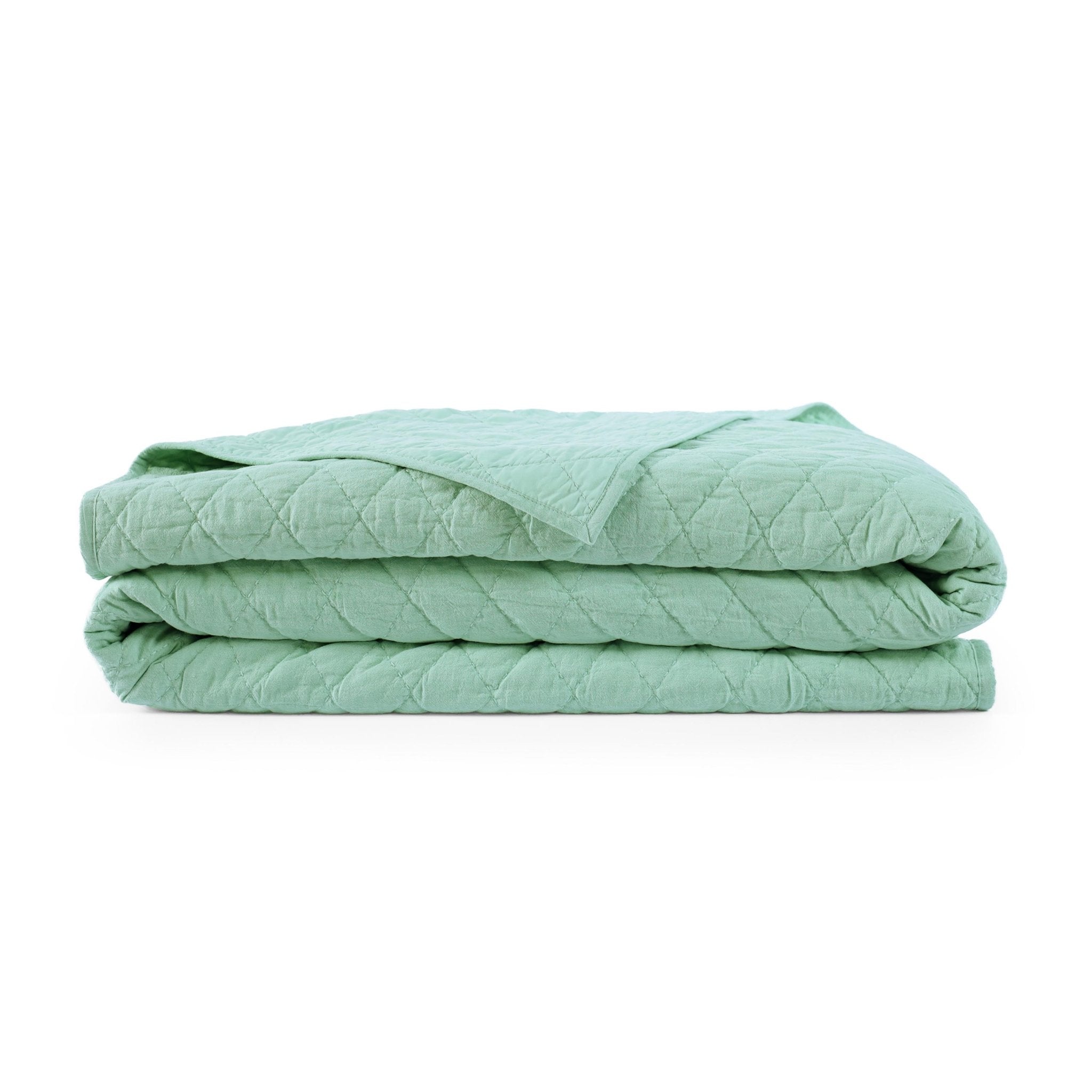 Green quilt with a white background.