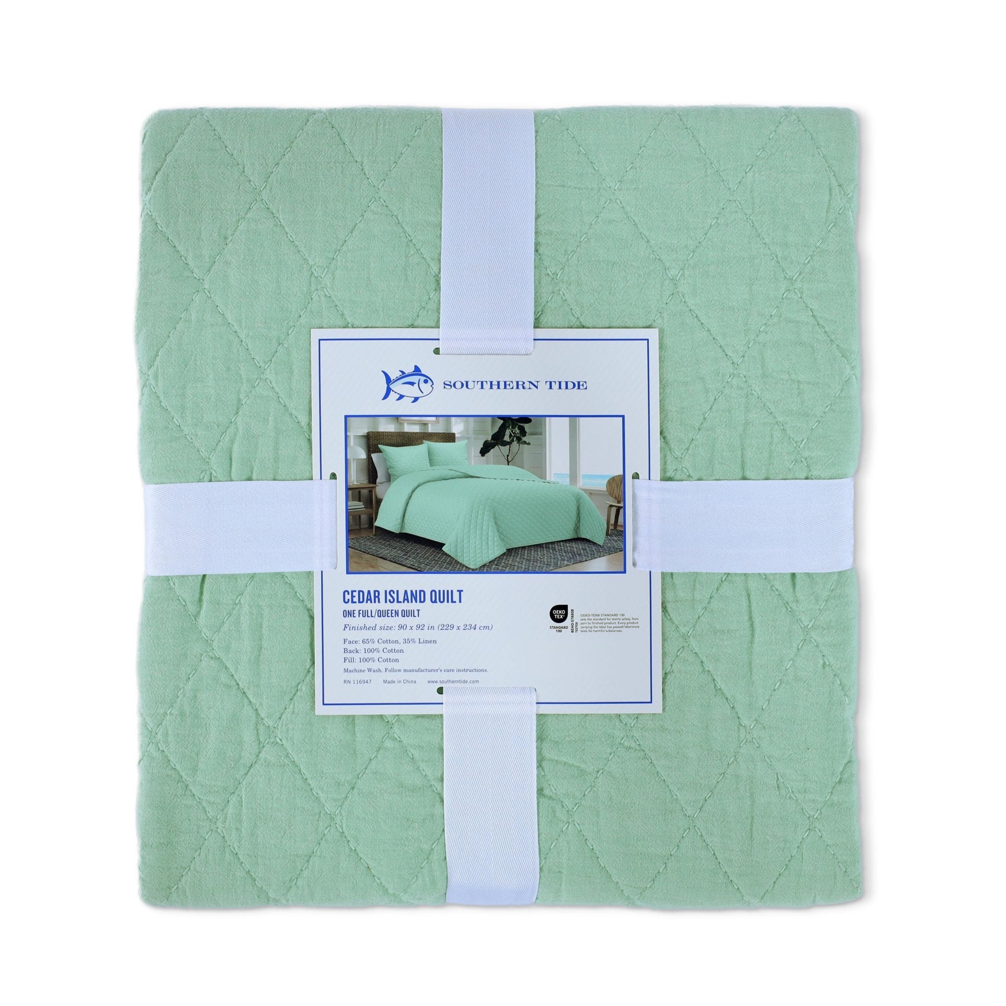 Back view of green quilt packaging with a tag displaying 'Southern Tide' on a white background