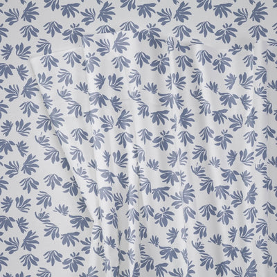 Blue leaf pattern on a white fabric background