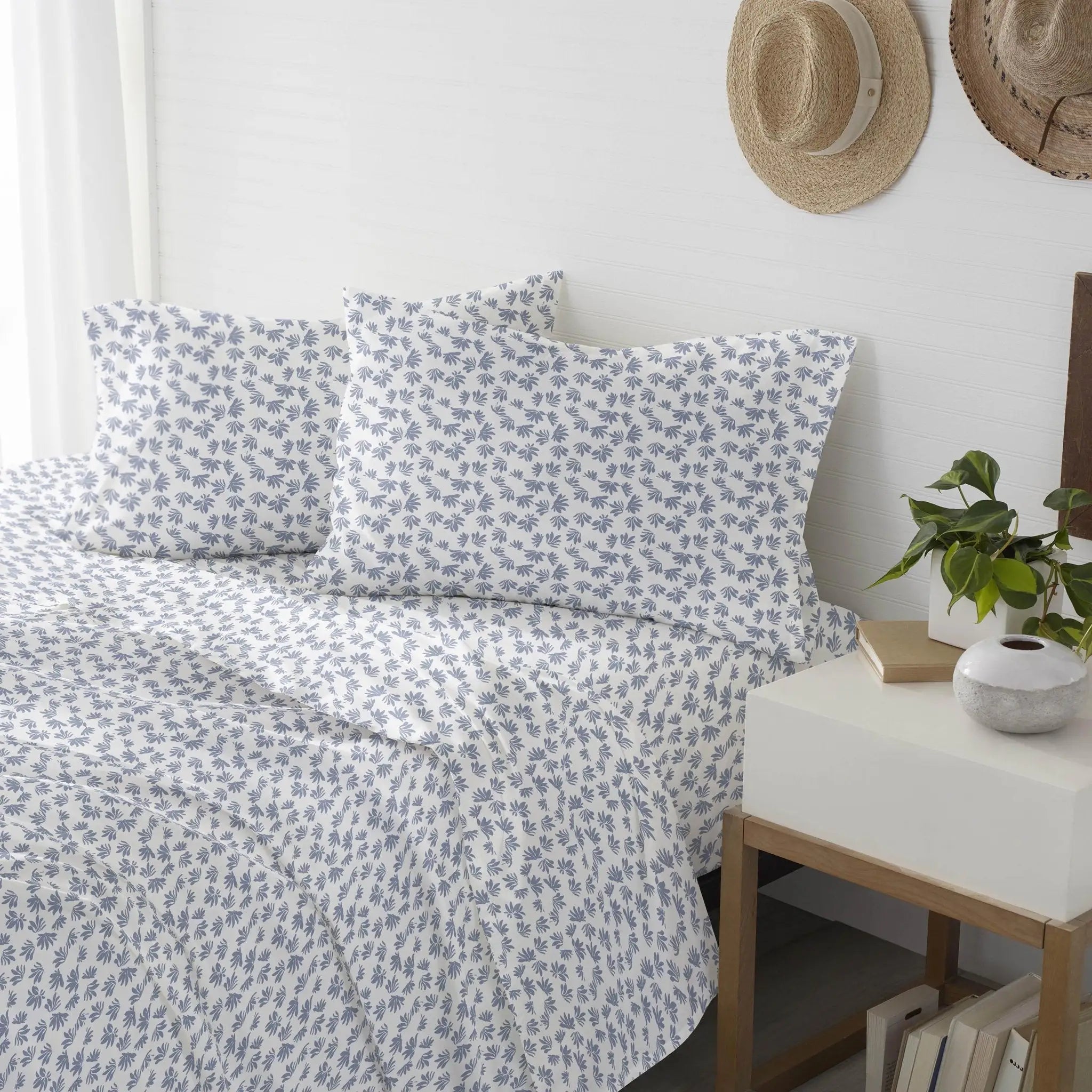 Floral patterned bedding set on a bed.